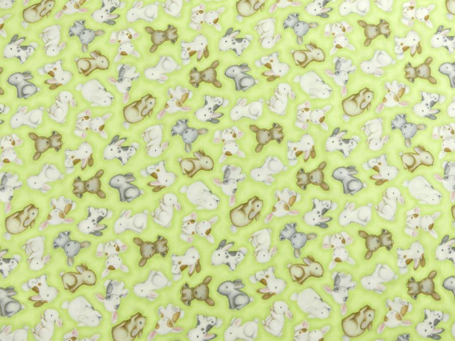 Patchworkstoff mit süßen Hasenbabies auf hellgrünem Untergrund